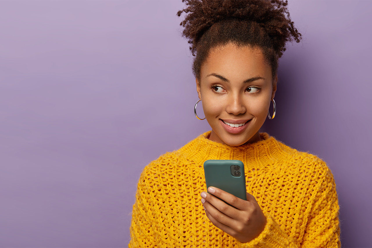 Woman smiling with phone in her hand