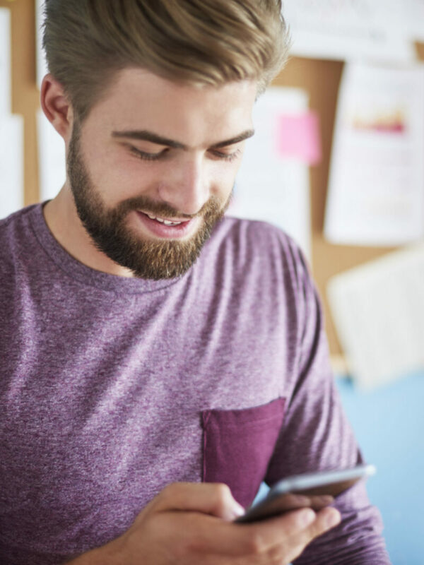 Man In Purple Clothes Using His Phone