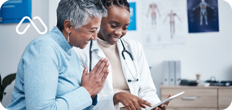 woman and her doctor looking at an ipad in a doctors office