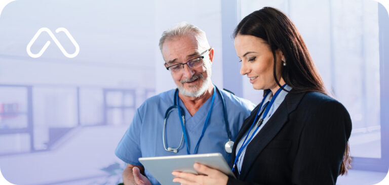 Man and women looking at an ipad in a medical setting